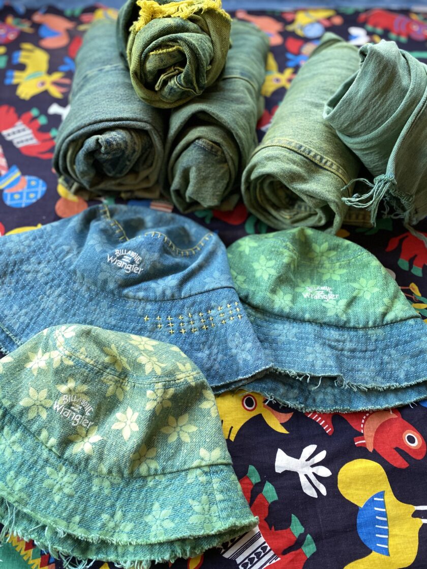 A group of hats and blankets laid out on a table.