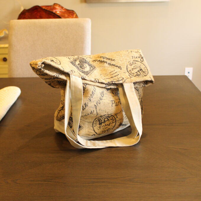 A bag sitting on a table next to a chair.