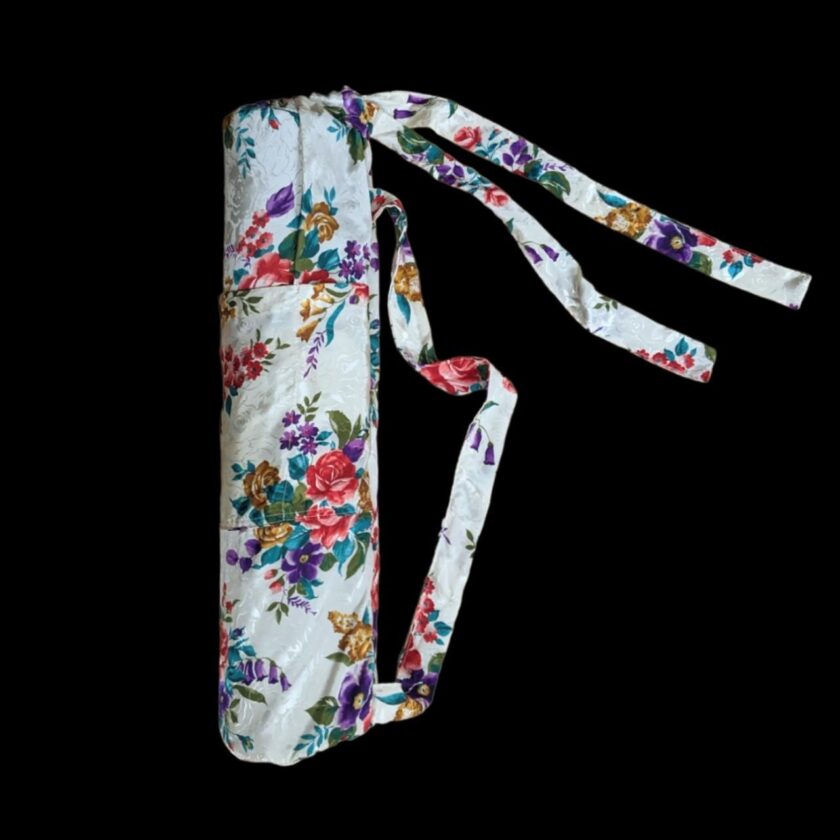 A white yoga bag with a floral pattern.