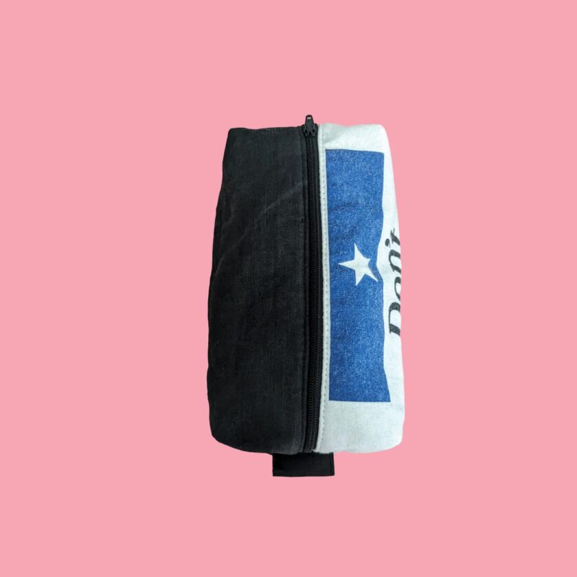 A toiletry bag with a texas flag on it.