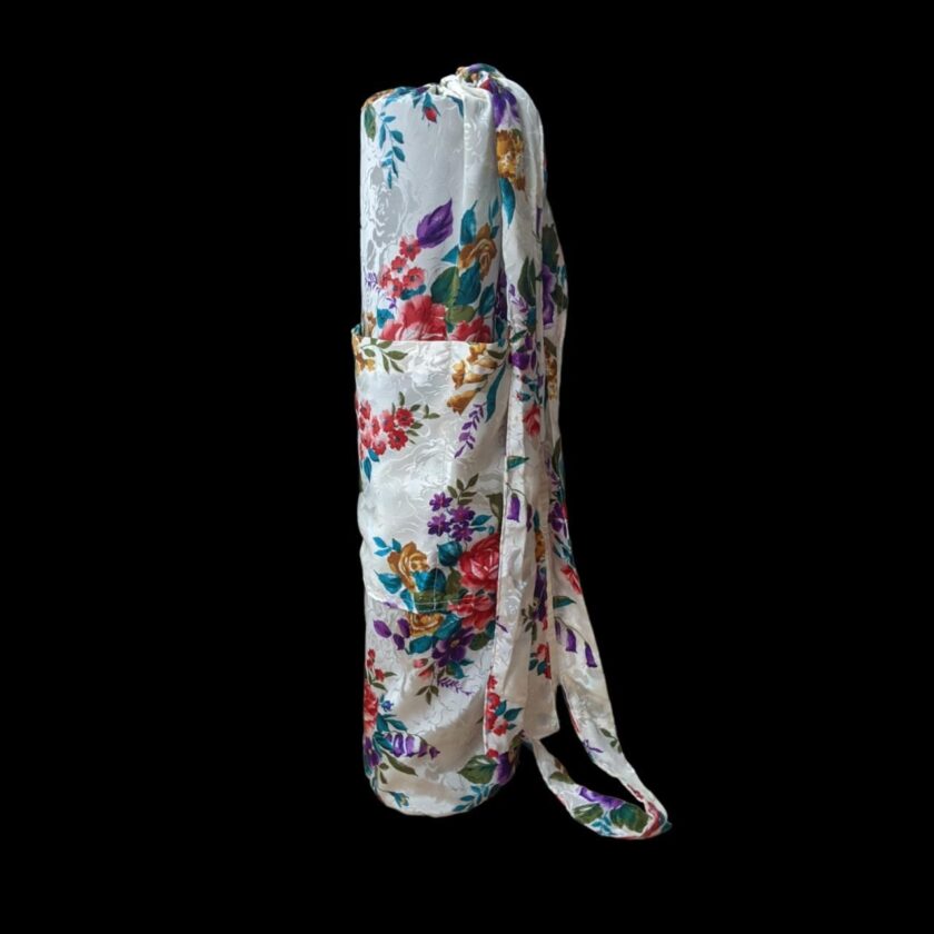A white and multicolored floral scarf on a black background.