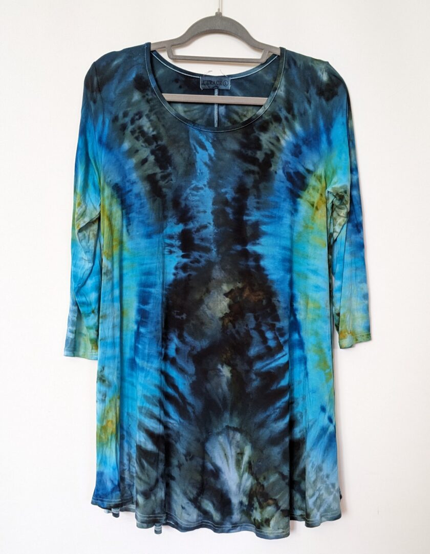 A blue and black tie dye shirt on a swinger.
