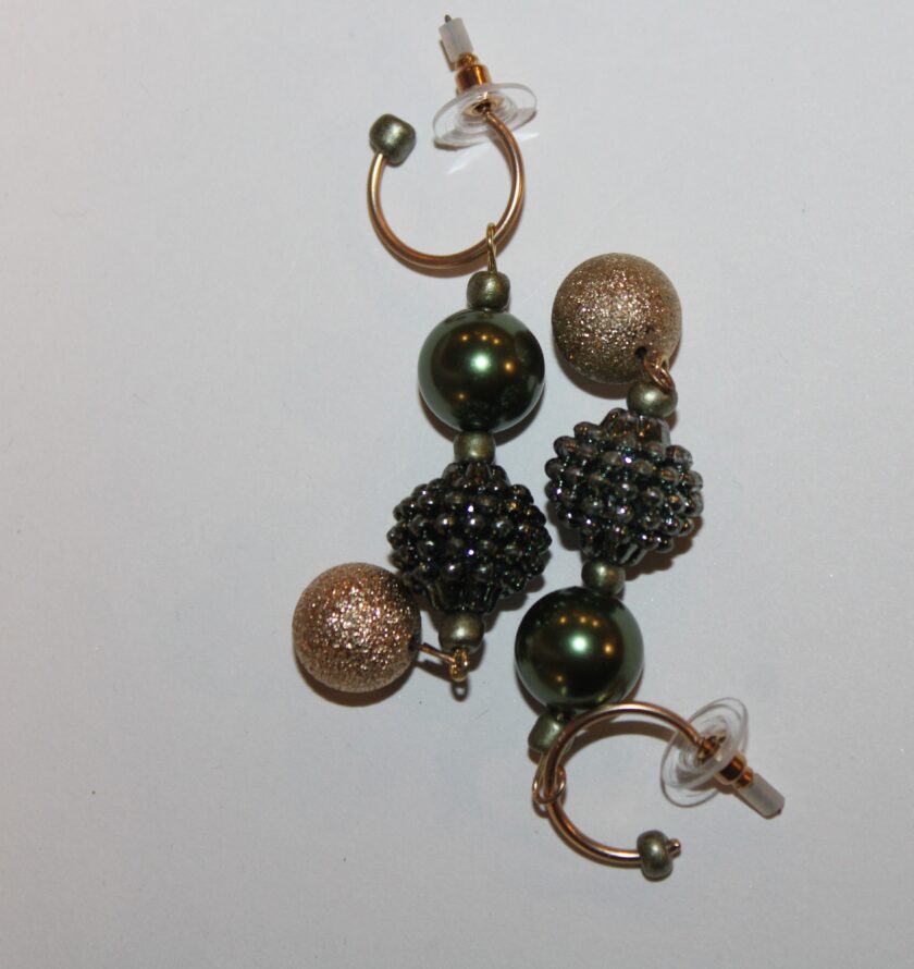 A pair of earrings with green and gold beads.
