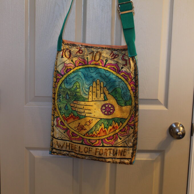 A bag hanging on a door.
