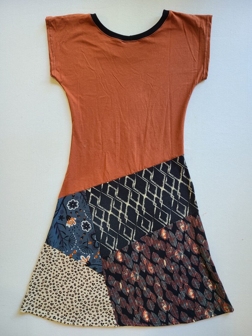 An orange and black dress with a patchwork pattern.