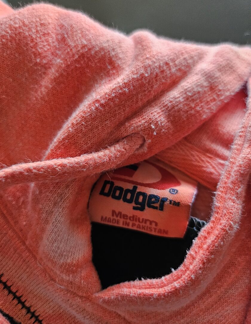 Orange hoodie with a brand label indicating size and country of manufacture.