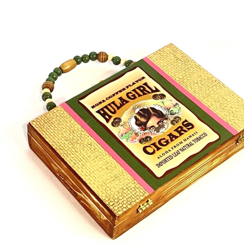 A wood cigar box purse with a hula girl label on it.