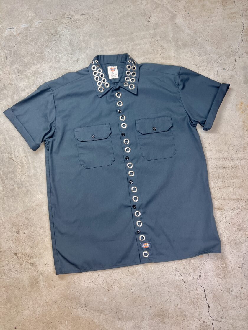A blue shirt with studs on the collar.