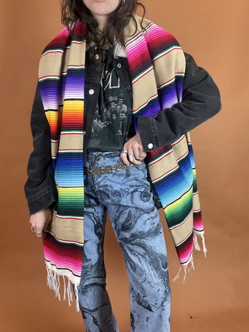 A person wearing a colorful blanket.