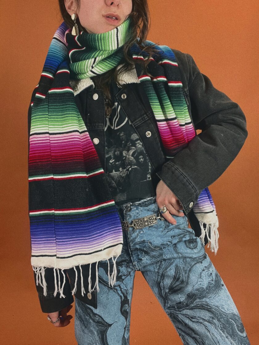 A woman wearing a colorful mexican scarf.
