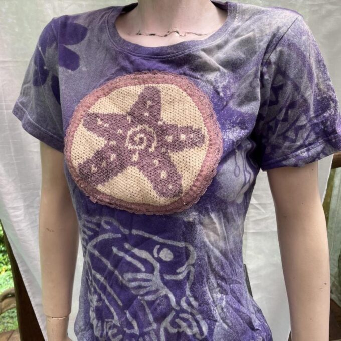 Purple t - shirt with a starfish on it.