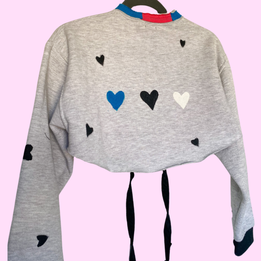 A grey sweatshirt with hearts on it.