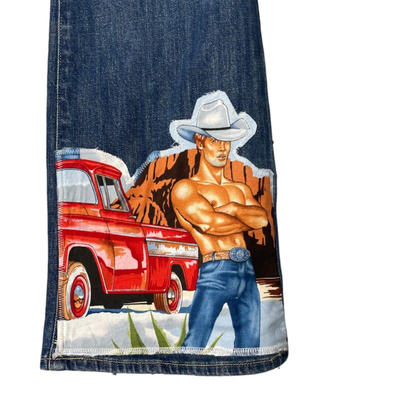 Illustration of a cowboy with crossed arms and a red truck on a denim background.