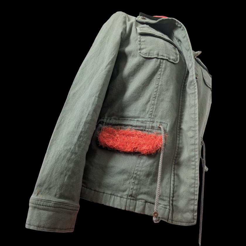 A jacket with a furry pocket on it.