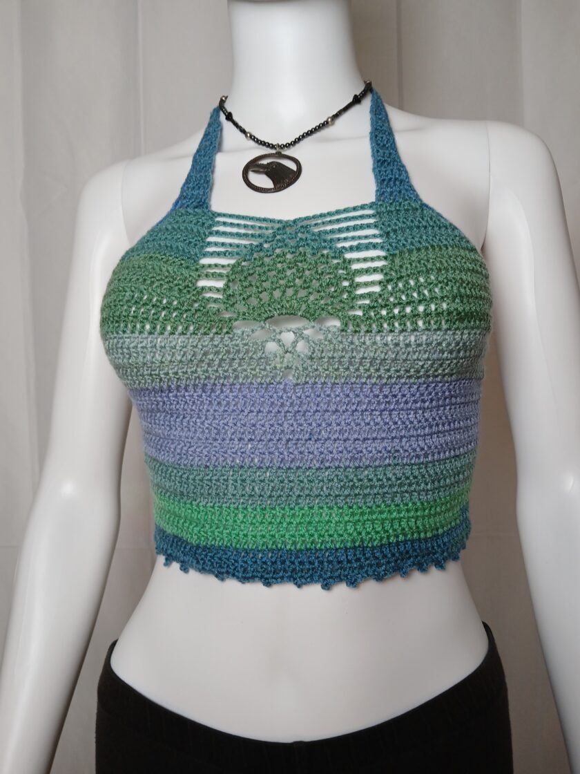 Green and purple crochet top with pineapple design on a mannequin