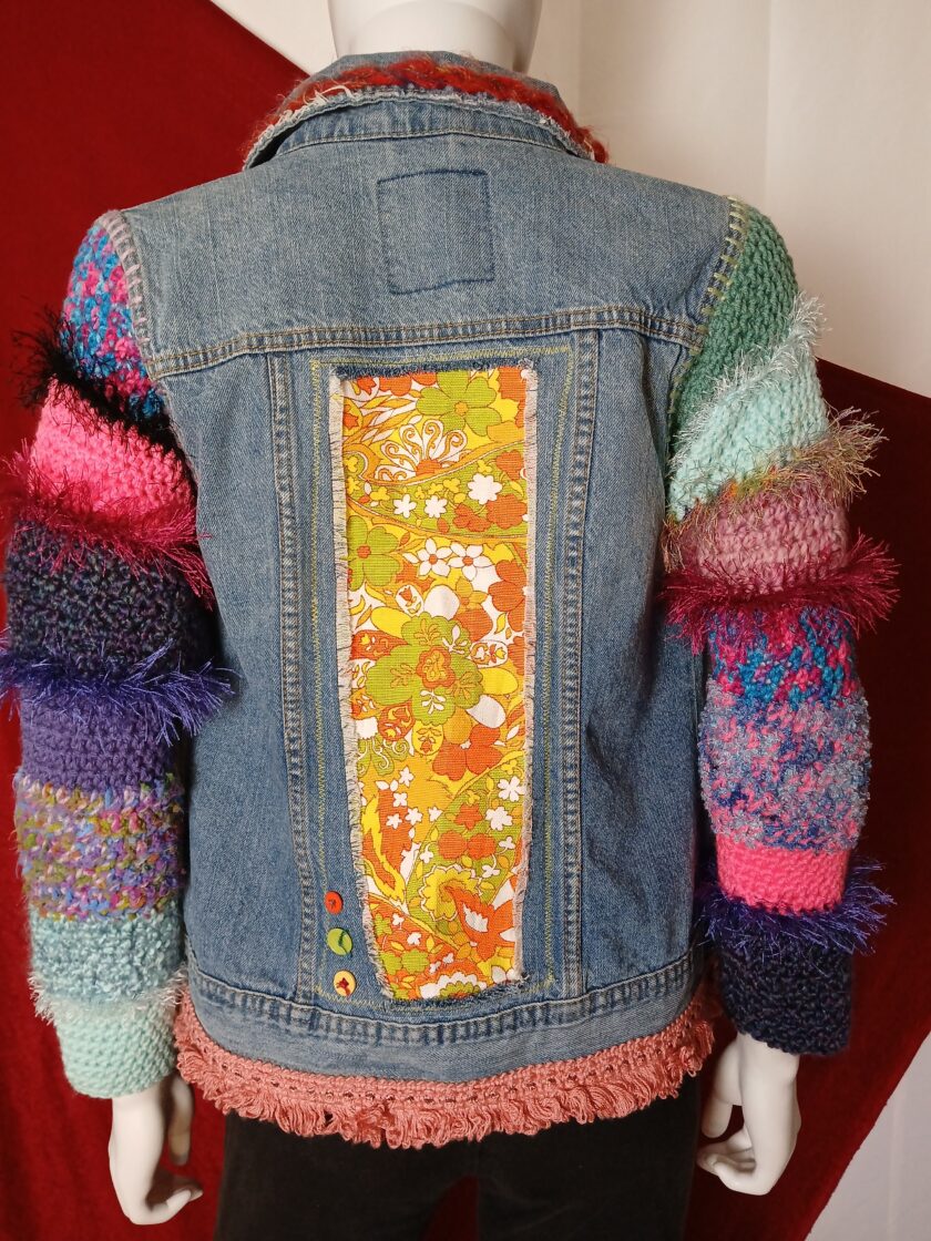 Hippie style denim jacket with vintage fabric applique, crochet sleeves and fringe bottom