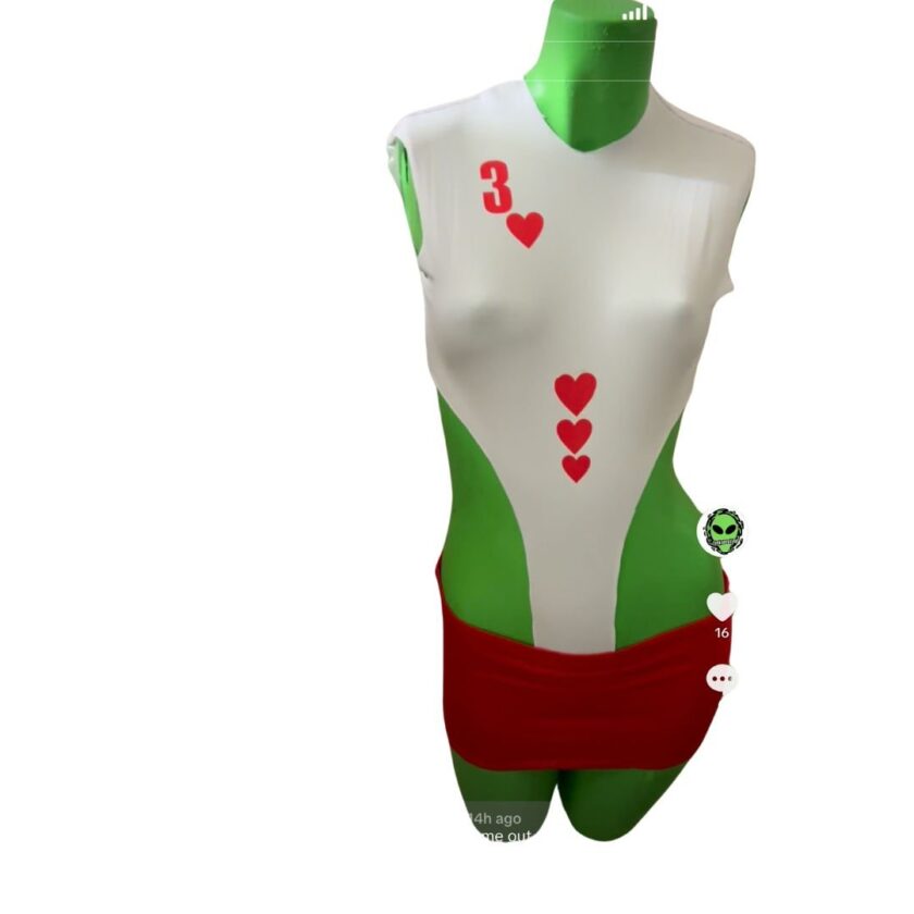Mannequin displaying a white and red playing card-themed sleeveless top with heart symbols and a red skirt.
