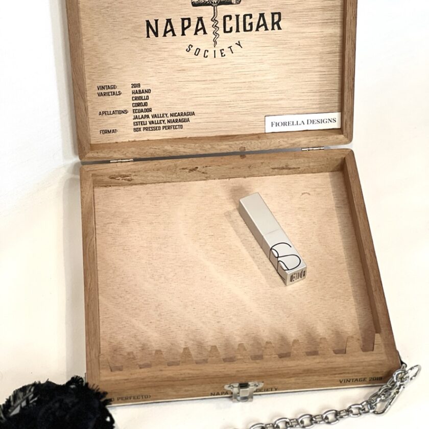 An open wooden cigar box purse labeled "Napa Cigar Society"