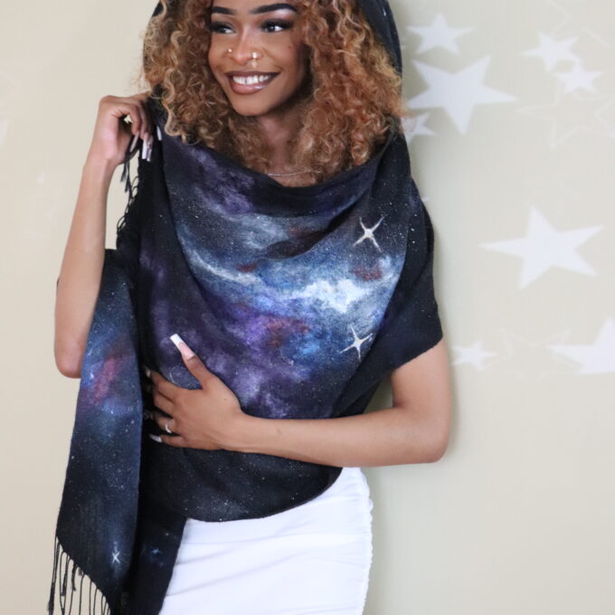 Woman wearing a hand-painted space scarf