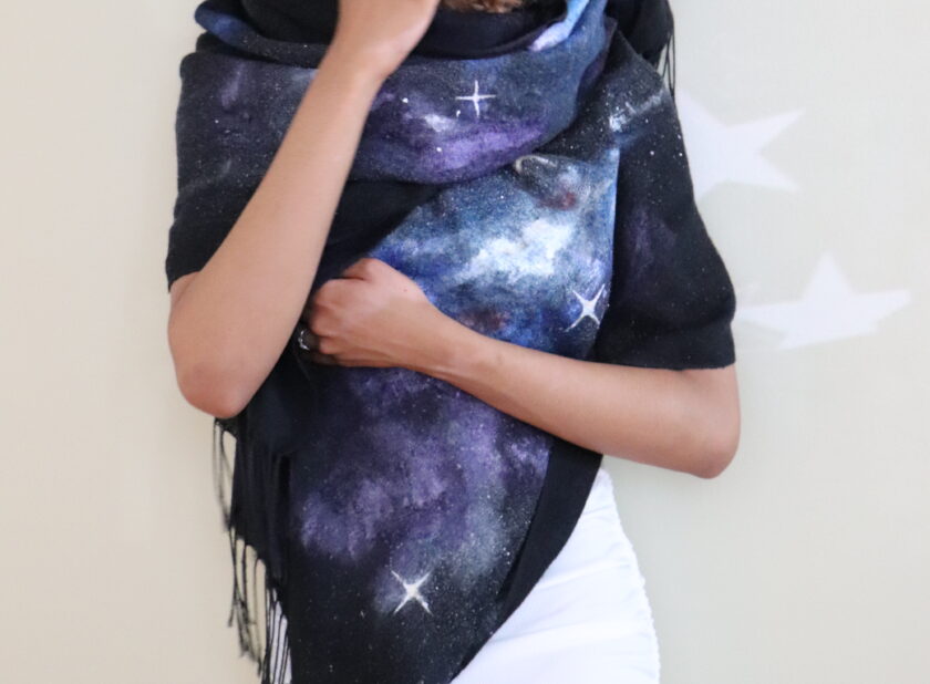 close up of a space scarf wrapped around a woman's shoulders